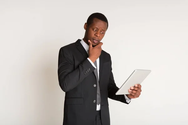 Надійний бізнесмен у костюмі стоїть, тримаючи планшет під рукою. Портрет — стокове фото