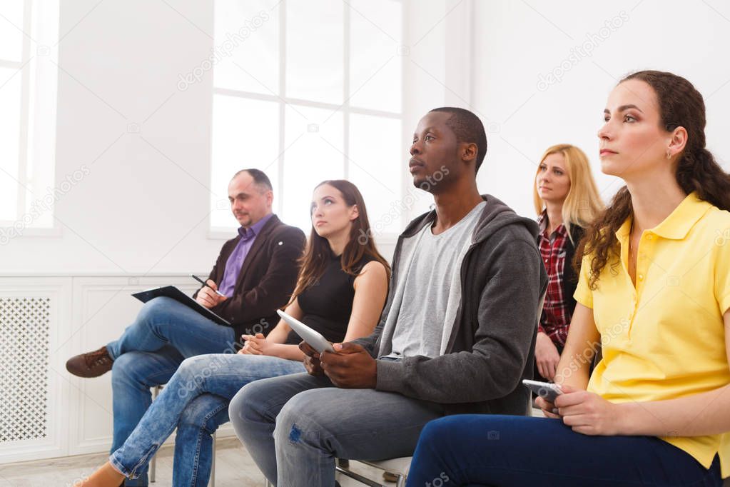 Group of people sitting at seminar, copy space