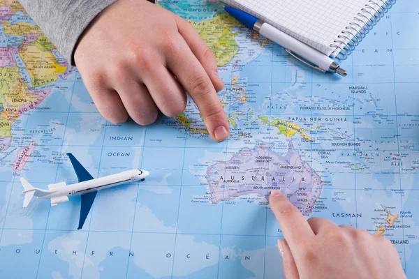 Couple planning trip to Australia, point on map