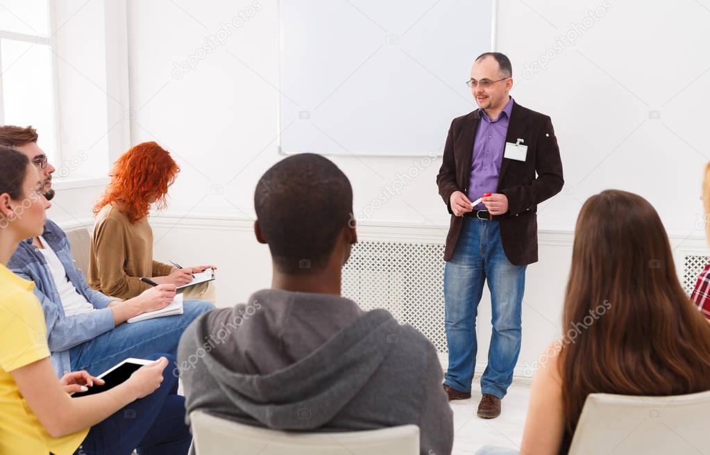 Adult man doing presentation in office copy space
