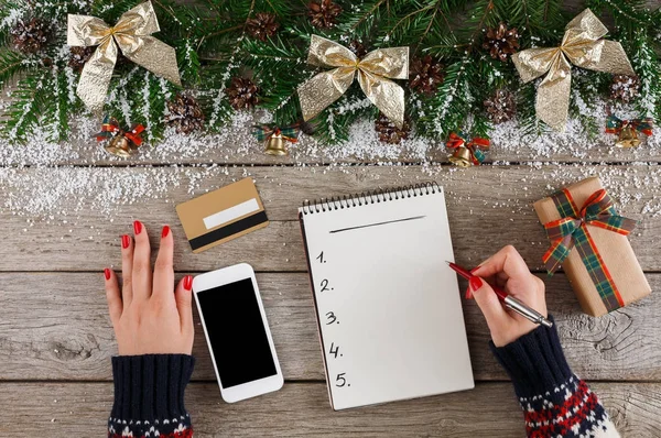 Christmas wish list on white wood table background
