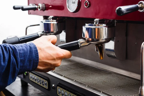 Closeup of barmen hand brewing espresso in professional coffee machine — Stock Photo, Image