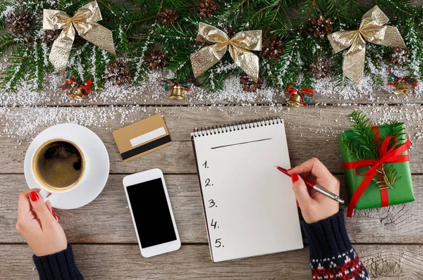 Christmas wish list on white wood table background