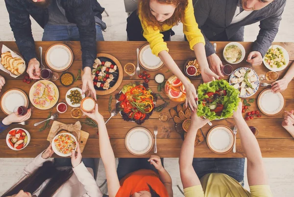 Mensen eten gezonde maaltijden op tafel geserveerd diner — Stockfoto