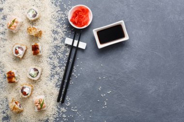 Suşi dizi en iyi görüntüyü rulo, rustik gri ve beyaz pirinç arka plan üzerinde maki