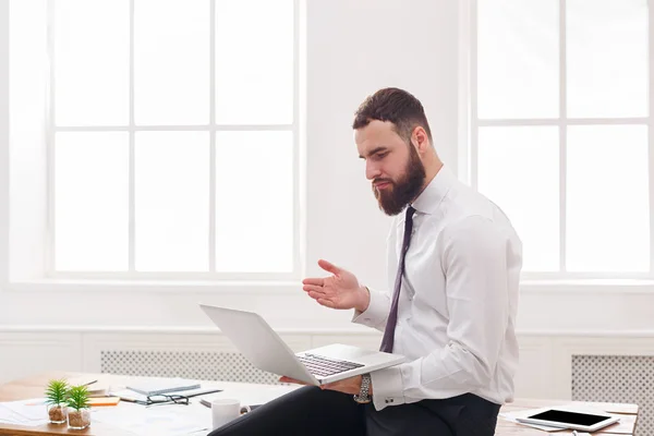 Hombre de negocios serio con el ordenador portátil en la oficina blanca moderna — Foto de Stock