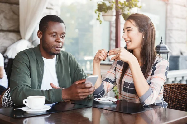 Молода пара використовує мобільні смартфони в кафе — стокове фото