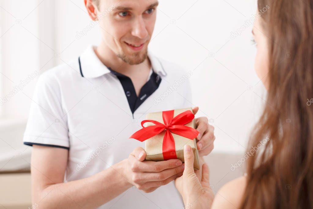 Happy couple exchanging gifts, copy space