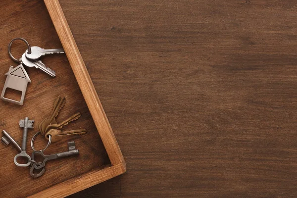 Mnoho různých klíčů na dřevěný tác — Stock fotografie