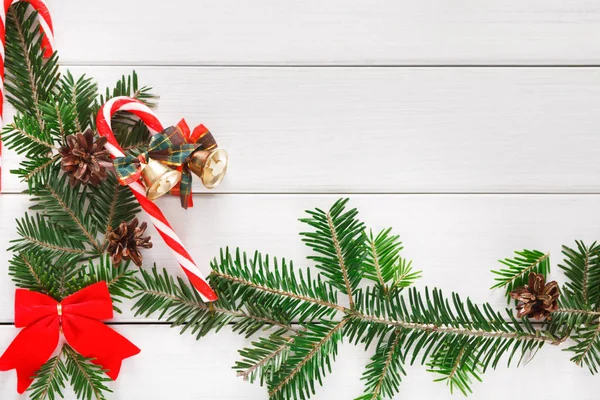 Christmas background with candies and fir tree border on wood — Stock Photo, Image