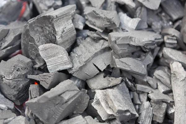 Carbón ardiendo en el fondo texturizado parrilla — Foto de Stock