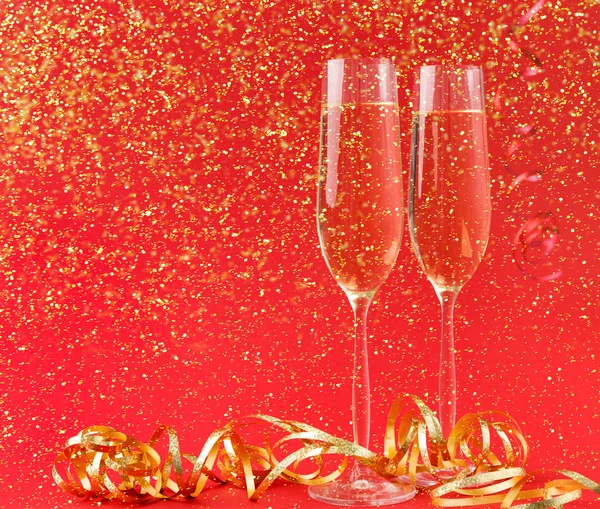 Flûtes à champagne sur fond de vacances rouge — Photo