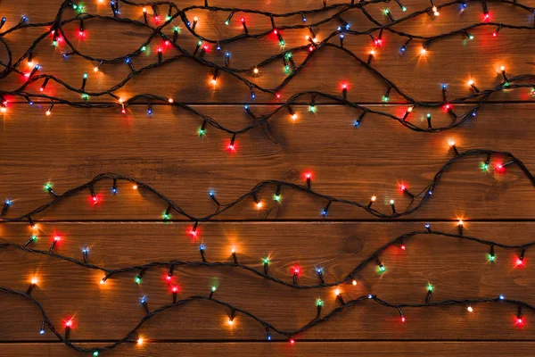 Christmas lights on wood background — Stock Photo, Image