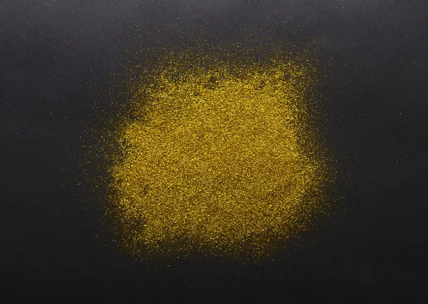Golden glitter sand texture on black background — Stock Photo, Image