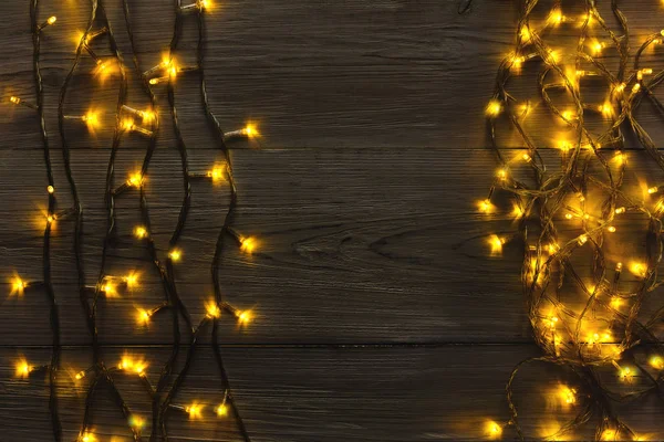 Kerstverlichting grens op grijze houten achtergrond — Stockfoto