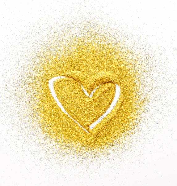 Sand painting. Golden glitter heart on white