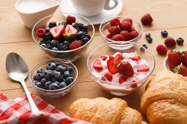 Continental breakfast with croissants and berries on natural wood Stock Image