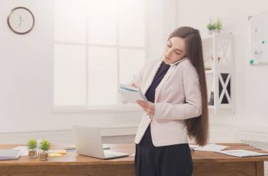 Ciddi iş kadını telefonda konuşurken iş başında