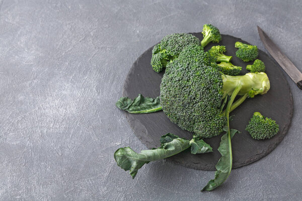 Rustic slate stone plate with broccoli, copy space, cooking backgroung.