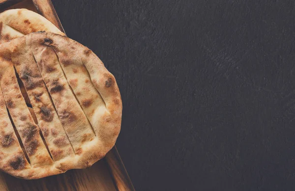 Tandoori bread on black background, copy space — Stock Photo, Image