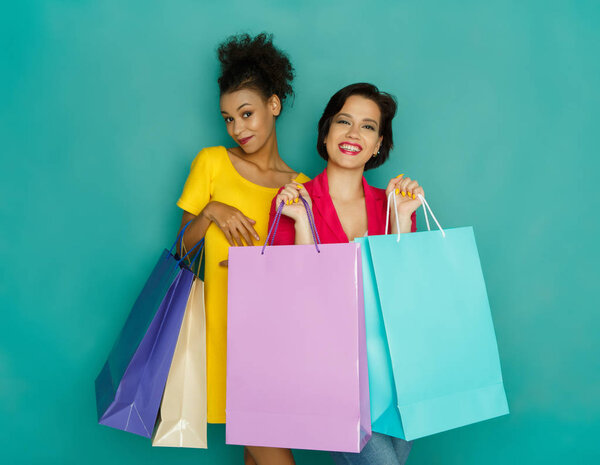 Happy multiethnic girls with shopping bags