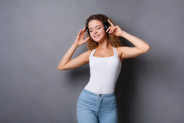 Mujer escuchar música en los auriculares, toma de estudio — Foto de Stock