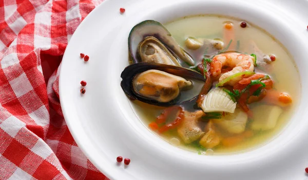 French seafood soup with white fish, shrimps and mussels in plate at wooden background — Stock Photo, Image