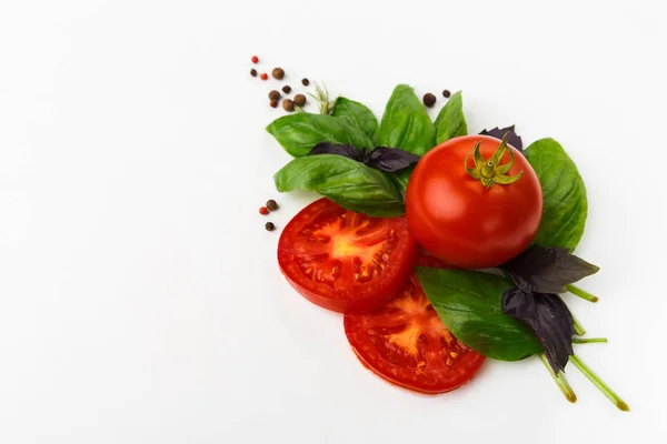 Red tomatoes and basil leaves isolated on white — Stock Photo, Image