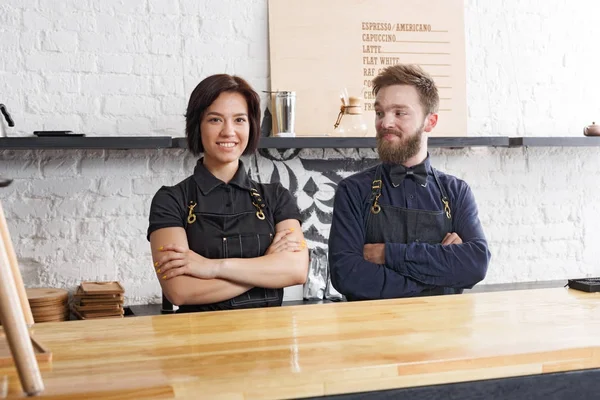 Bartenders masculinos e femininos em café uniforme no interior do café — Fotografia de Stock