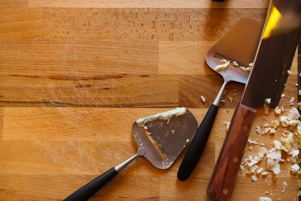 Cheese knives on rustic wood background, copy space — Stock Photo, Image