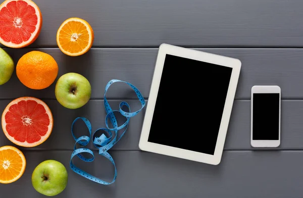 Fruit, measuring tape and blank tablet mockup — Stock Photo, Image