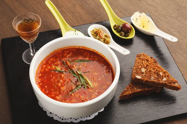 Delicious russian soup with snacks and drink