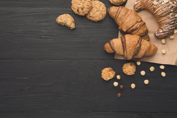 stock image Homemade french croissants and cookies on wood