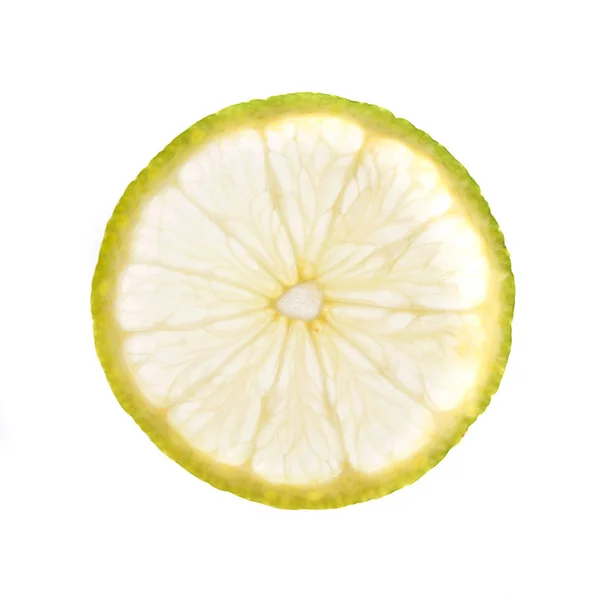 Yeşil limon dilimi arkadan aydınlatmalı, üzerinde beyaz izole — Stok fotoğraf