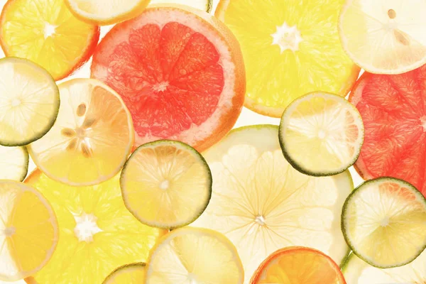 Podsvícené citrusových plodů plátky pozadí — Stock fotografie