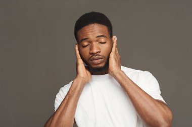 Black man covering ears with hands clipart