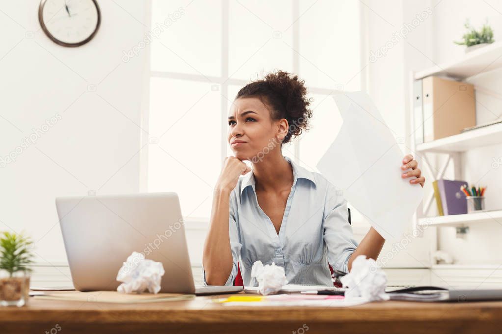 Angry business woman reading document at office desktop