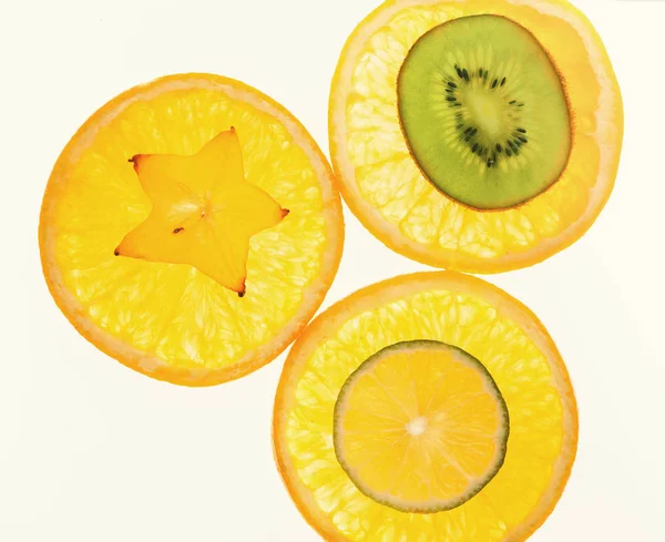 Backlit citrus fruits slices background — Stock Photo, Image