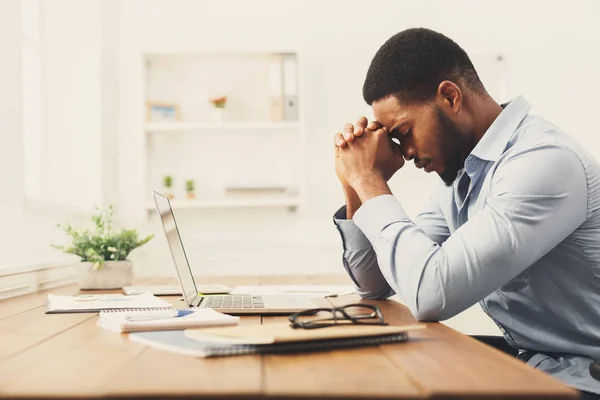 Overworking african-american employee at workplace — Stock Photo, Image