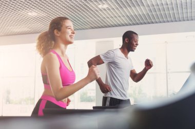 Erkek ve kadın, çift koşu bandı üzerinde spor salonunda