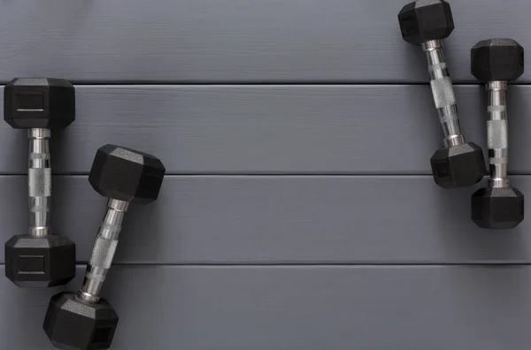 Dumbbells on grey background top view — Stock Photo, Image