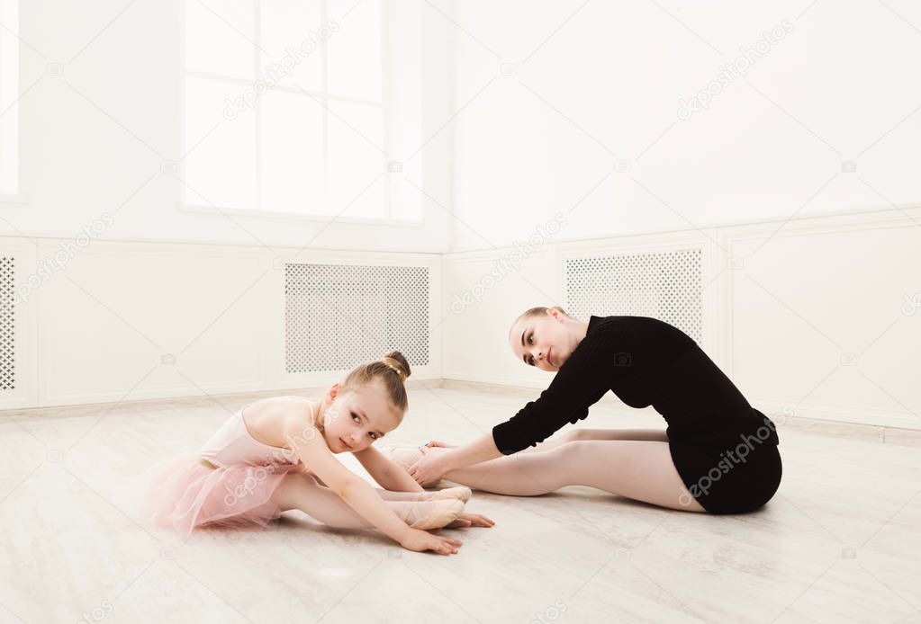 Little girl learn ballet with teacher copy space
