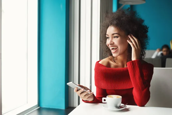 Boldog fekete lány kávézóban smartphone — Stock Fotó