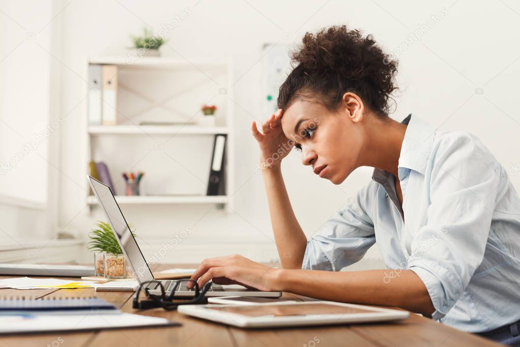 Concentrated business woman working on laptop at office