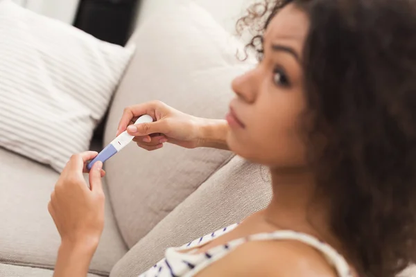 Worried girl reading results of her pregnancy test — Stock Photo, Image