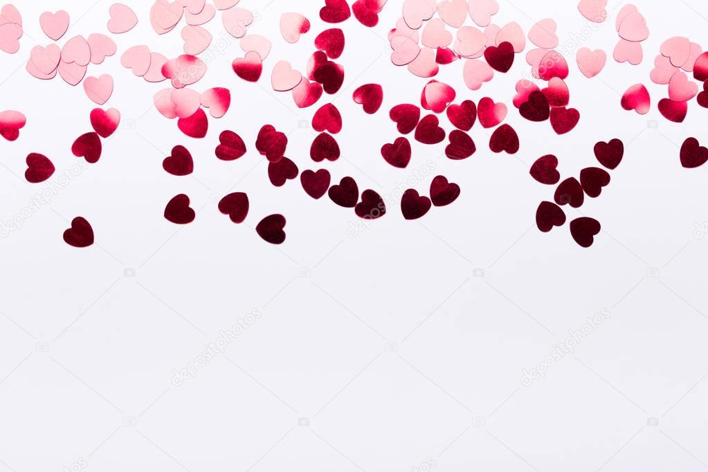 Red paper hearts on white background