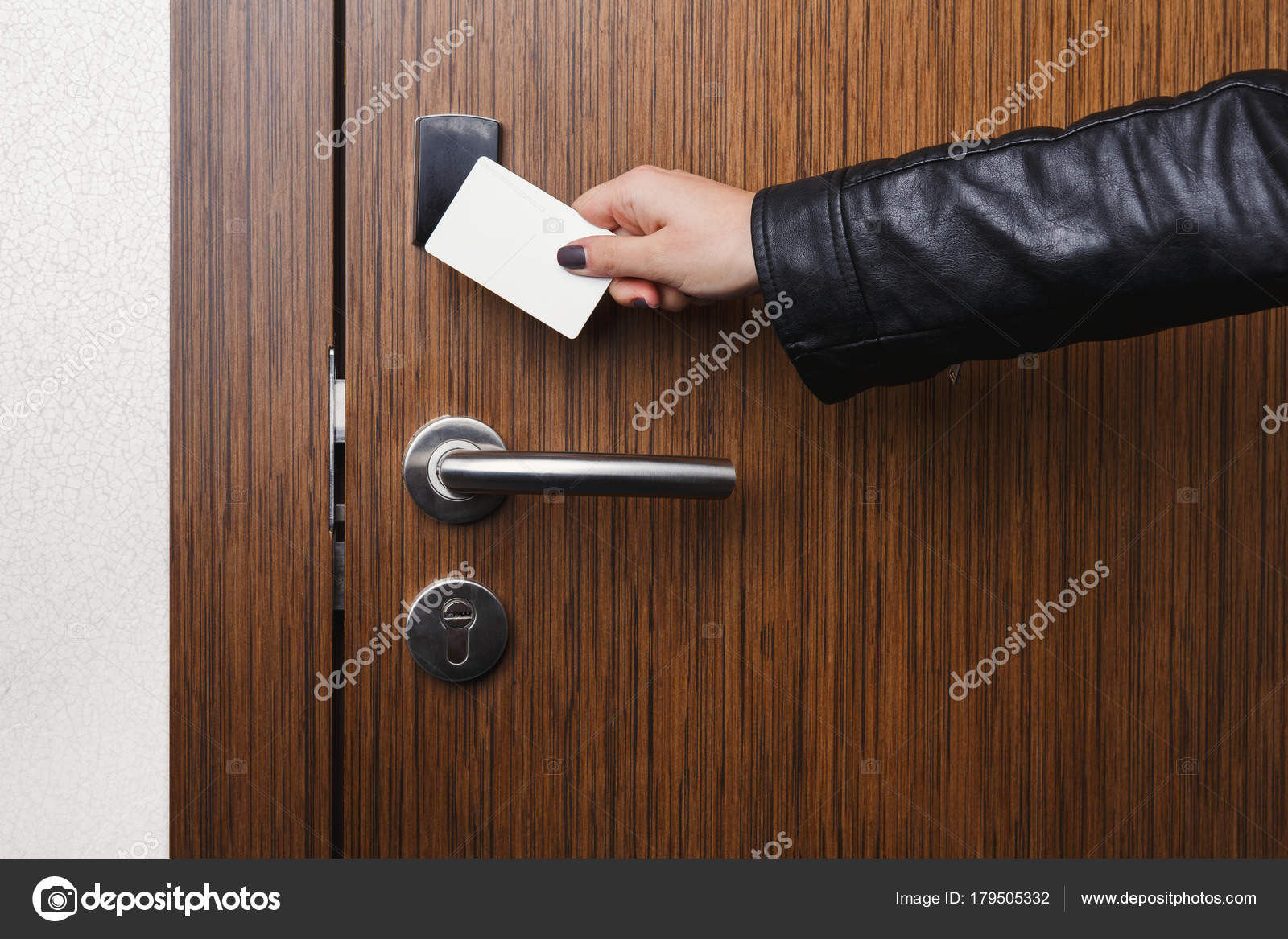 Hand inserting key card in electronic lock Stock Photo by Milkos