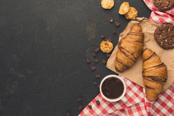 Freshly baked croissants and coffee background