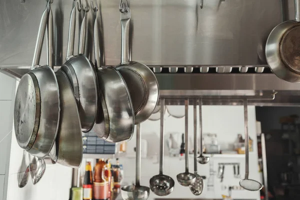 Modern restaurant kitchen interior with frying pans — Stock Photo, Image