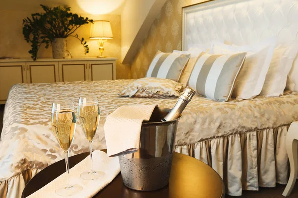 Two glasses and bottle of champagne in hotel — Stock Photo, Image